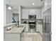 Modern kitchen boasting granite counters, stainless appliances, and a seamless flow to the living area at 1069 Lexi Ct, Ladson, SC 29456