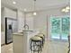 Bright kitchen featuring a breakfast bar with seating, stainless steel appliances, and sliding door access to the outdoors at 1069 Lexi Ct, Ladson, SC 29456