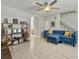 Comfortable living room featuring a sectional couch, ceiling fan, staircase, and built-in bookshelves at 1069 Lexi Ct, Ladson, SC 29456