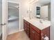 Bright bathroom features a double sink vanity, tile floors, and access to the main bedroom at 107 Brookhaven Rd, Summerville, SC 29486