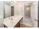 A bathroom vanity with a large mirror, dark cabinets, and an open doorway to a carpeted hallway at 107 Brookhaven Rd, Summerville, SC 29486