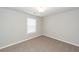 This bedroom boasts neutral paint and carpet and a large window for ample natural light at 107 Brookhaven Rd, Summerville, SC 29486
