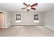 This bedroom features two windows with shades, neutral carpet and walls, and a ceiling fan at 107 Brookhaven Rd, Summerville, SC 29486