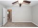 A neutral-toned bedroom with a ceiling fan and open doorway showcases a clean and simple design at 107 Brookhaven Rd, Summerville, SC 29486