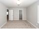 Bedroom features neutral paint and carpet with overhead lighting and access to a walk-in closet at 107 Brookhaven Rd, Summerville, SC 29486
