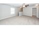This bonus room features neutral carpet, a ceiling fan, a window, and stairs to the left at 107 Brookhaven Rd, Summerville, SC 29486