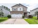 Two-story home with attached two-car garage, concrete driveway, and manicured lawn at 107 Brookhaven Rd, Summerville, SC 29486