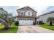 Two-story house featuring a white garage door, concrete driveway, and partial lawn at 107 Brookhaven Rd, Summerville, SC 29486