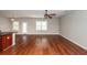 Open-concept living area with wood floors and a ceiling fan, seamlessly connecting to the dining area at 107 Brookhaven Rd, Summerville, SC 29486
