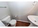 This powder room features a sleek pedestal sink, toilet, and wood-look flooring at 107 Brookhaven Rd, Summerville, SC 29486