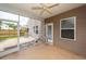 A screened-in porch with an outdoor fan and view of the home's exterior at 107 Brookhaven Rd, Summerville, SC 29486