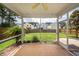 View from a screened-in porch looking out to the backyard and neighboring houses at 107 Brookhaven Rd, Summerville, SC 29486