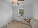 Comfortable bedroom with sofa, ceiling fan, and a bright window with outdoor view at 11 America St, Charleston, SC 29403