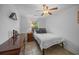 Comfortable bedroom with soft lighting, ceiling fan, dresser, and view to the outdoors at 11 America St, Charleston, SC 29403