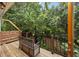 Charming deck area with a bench and view of the surrounding lush greenery at 11 America St, Charleston, SC 29403