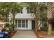 Charming two-story home with well-maintained landscaping and a gray front door at 11 America St, Charleston, SC 29403