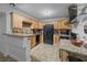 Spacious kitchen featuring granite countertops, wood cabinets, and black appliances at 11 America St, Charleston, SC 29403