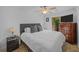 Comfortable main bedroom with plush bedding, ceiling fan, and door to outdoor deck at 11 America St, Charleston, SC 29403
