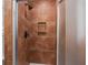 Bathroom shower featuring bronze fixtures, and earth tone tiling with a soap shelf at 11 America St, Charleston, SC 29403