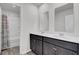 Bathroom with double sinks, white countertops, and dark cabinets at 110 Cardinal Flower Ct, Moncks Corner, SC 29461