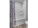 Clean bathroom with a white shower-tub combo and white walls, accented by a blue marble shower curtain at 110 Cardinal Flower Ct, Moncks Corner, SC 29461