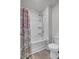 Bathroom featuring a bathtub with shower, white walls, and vinyl flooring at 110 Cardinal Flower Ct, Moncks Corner, SC 29461