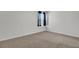 Bright bedroom with neutral carpet, light walls and a single window with dark blue curtains and blinds at 110 Cardinal Flower Ct, Moncks Corner, SC 29461