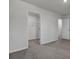 Carpeted bedroom with walk-in closet and a view of other rooms through an open doorway at 110 Cardinal Flower Ct, Moncks Corner, SC 29461