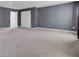 Large bonus room with carpet flooring, gray walls, multiple windows with drapes and a double door closet at 110 Cardinal Flower Ct, Moncks Corner, SC 29461