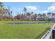 Scenic community space with lush green lawn and expansive retention pond surrounded by mature trees and blue sky at 110 Cardinal Flower Ct, Moncks Corner, SC 29461