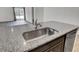 Close up of a granite countertop, stainless steel sink, and faucet at 110 Cardinal Flower Ct, Moncks Corner, SC 29461