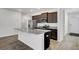 Modern kitchen featuring a granite island, stainless steel appliances and dark wood cabinetry at 110 Cardinal Flower Ct, Moncks Corner, SC 29461