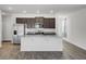 Modern kitchen featuring a granite island, stainless steel appliances and dark wood cabinetry at 110 Cardinal Flower Ct, Moncks Corner, SC 29461