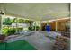 Spacious covered patio featuring concrete flooring, brick accents, and a serene backyard view at 1121 Armstrong Ave, Charleston, SC 29407