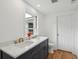 Bathroom featuring dual sinks with marble counters and a large window at 1121 Armstrong Ave, Charleston, SC 29407