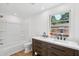 Bathroom with a double sink vanity, bathtub and a window with natural light at 1121 Armstrong Ave, Charleston, SC 29407