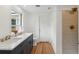 Bathroom featuring dual sinks with marble counters, a shower, and a large window at 1121 Armstrong Ave, Charleston, SC 29407