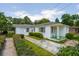 Charming one-story home featuring a neatly landscaped front yard and a welcoming entryway at 1121 Armstrong Ave, Charleston, SC 29407