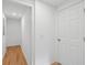 Bright hallway with white walls and doors and wood floors at 1121 Armstrong Ave, Charleston, SC 29407