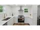 Modern kitchen with white cabinetry, stainless steel appliances, and sleek countertops at 1121 Armstrong Ave, Charleston, SC 29407
