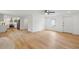 Open living room leading into the kitchen, featuring wood-look floors and ample natural light at 1121 Armstrong Ave, Charleston, SC 29407