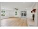 Bright living room featuring a decorative fireplace, ceiling fan, and wood-look floors at 1121 Armstrong Ave, Charleston, SC 29407