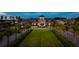 Community clubhouse with manicured lawn and palm trees at 118 Magnolia House Dr, Summerville, SC 29486