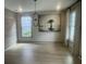 Stylish dining room with modern lighting fixture, large windows, and decorative artwork. Perfect for entertaining guests at 118 Magnolia House Dr, Summerville, SC 29486