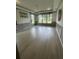 Spacious dining room with wood floors, large windows, decorative trim, and a stylish light fixture for a sophisticated touch at 118 Magnolia House Dr, Summerville, SC 29486