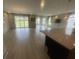 Open-concept living room with wood floors and sliding glass doors that lead to the backyard for indoor-outdoor living at 118 Magnolia House Dr, Summerville, SC 29486