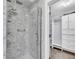 Contemporary bathroom with a glass-enclosed shower, marbled tile, and a closet at 1309 Llewellyn Rd, Mount Pleasant, SC 29464