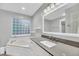 Modern bathroom featuring a soaking tub, a stylish vanity, and a large window for natural light at 1309 Llewellyn Rd, Mount Pleasant, SC 29464
