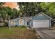 Charming blue home featuring an attached garage, front yard, and inviting entrance at 1309 Llewellyn Rd, Mount Pleasant, SC 29464