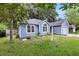 Charming home with lush lawn, garden bed, and a detached garage at 1309 Llewellyn Rd, Mount Pleasant, SC 29464